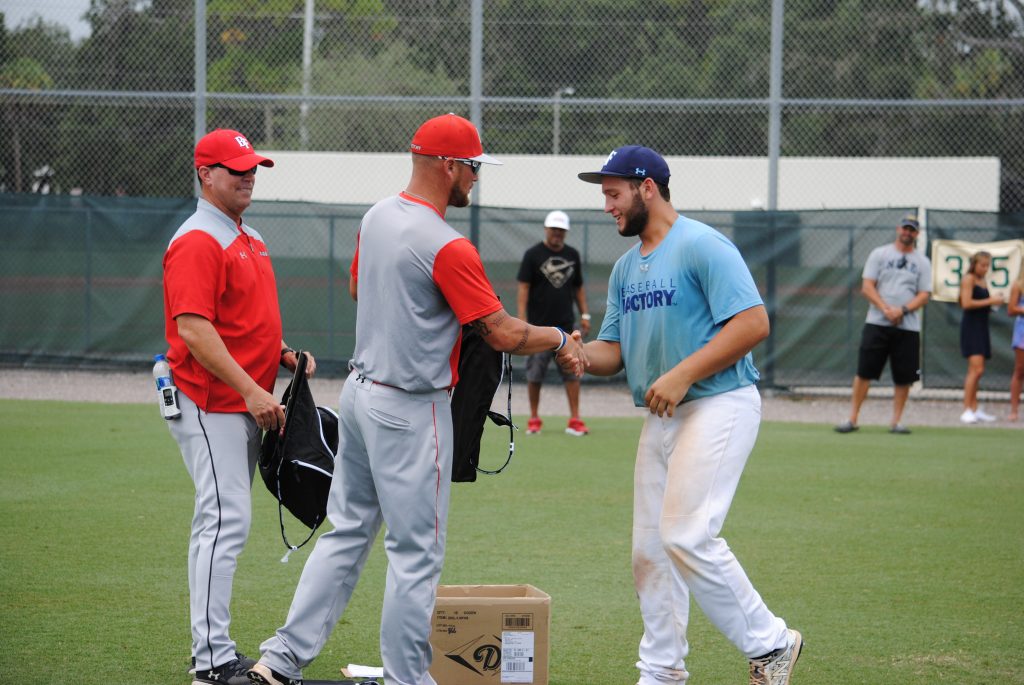Gonzalez, shakes hands with Coach Cross and Coach Lieby after winning MVP honors