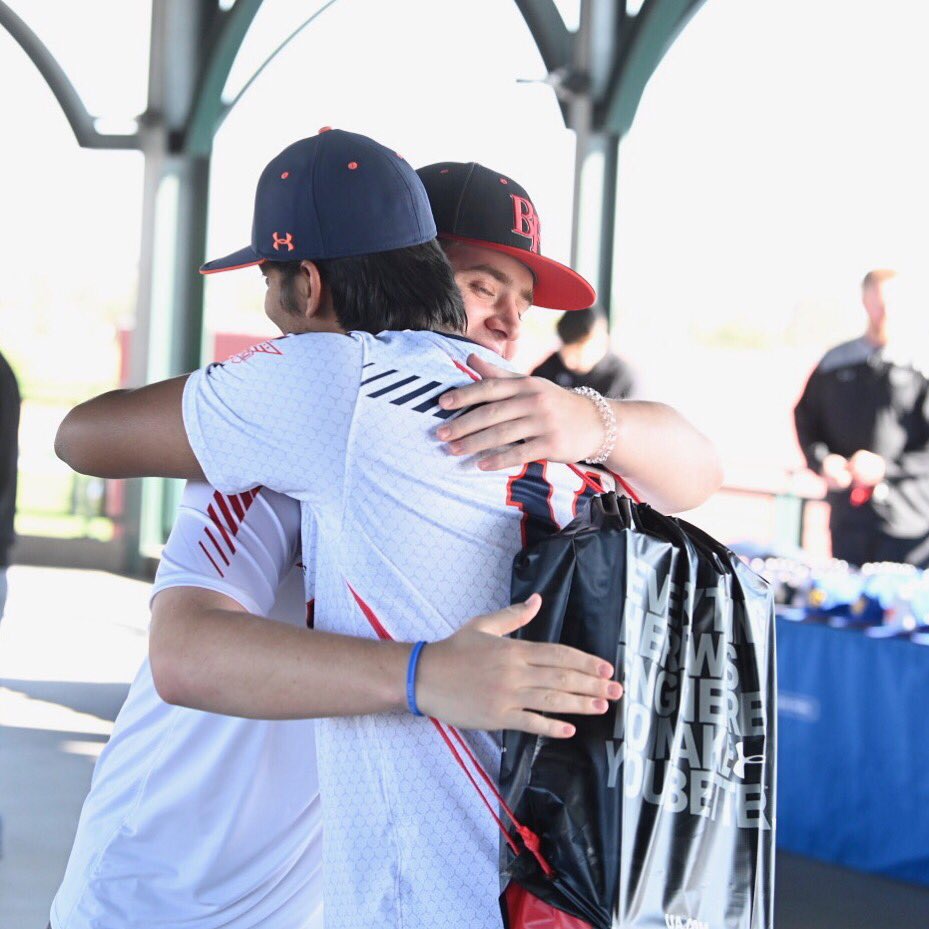 Friends embrace at All-America Pre-Season check-in (Photo courtesy: Matt Roth)